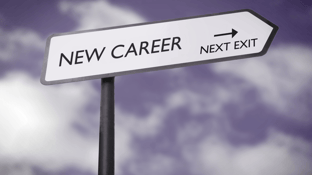 Road sign with an arrow pointing that says "NEW CAREER, NEXT EXIT"